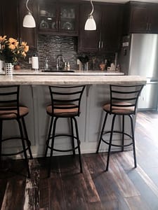 Rustic Alder Kitchen Cabinets with Tile Backsplash and a New Kitchen Island with a Raised Snack Bar and Cook Top